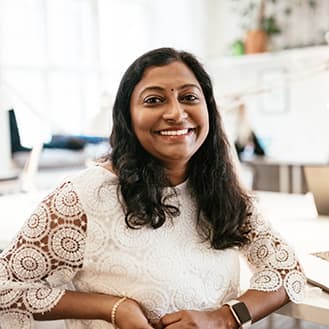 Female business owner smiling.