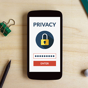 Mobile phone showing Privacy heading with hidden password entered Smiling Customer Service Representative seated at their desk.